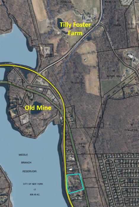 Modern aerial photograph showing the Tilly Foster Farm to the north, the flooded Old Mine pit at left, and the property parcel outlined to the lower right.