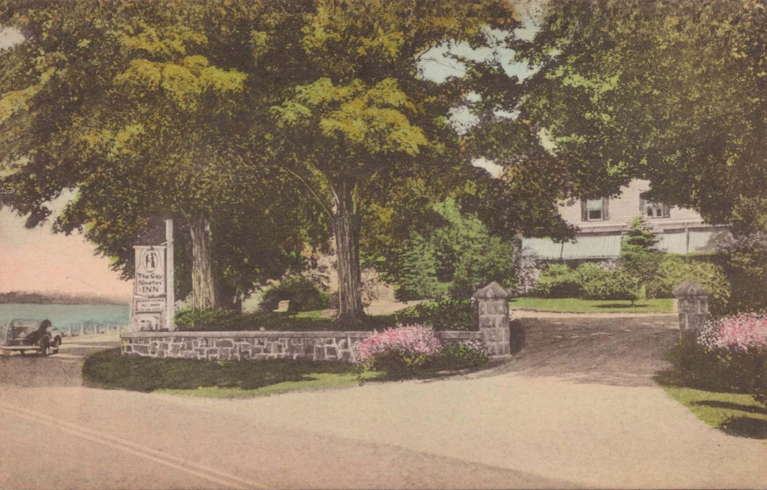 The Gay Nineties Inn, Brewster, N.Y. — hand-tinted postcard showing the entrance gateway and the inn beyond, with the Middle Branch Reservoir visible at left.