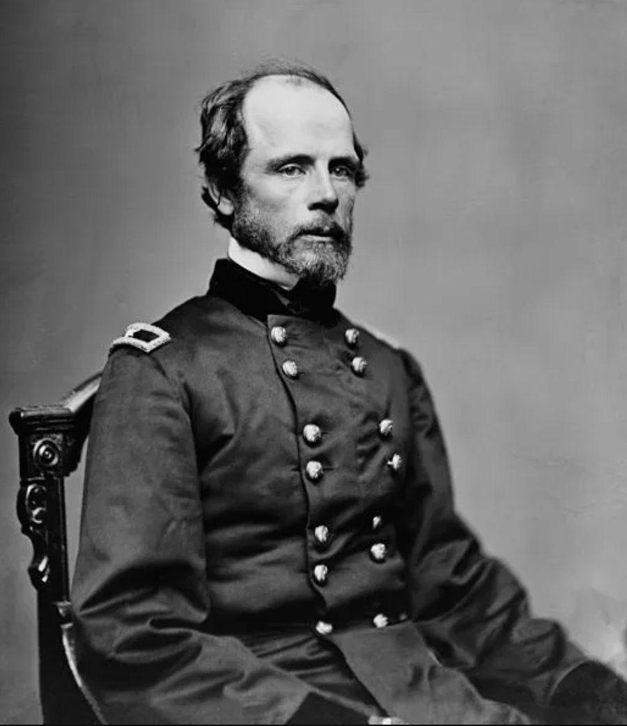 Half-length seated photograph of Major General Darius Nash Couch in Union uniform, showing the two-star shoulder strap of a major general. He has a full beard, receding hairline, and looks slightly to his right against a plain studio backdrop.