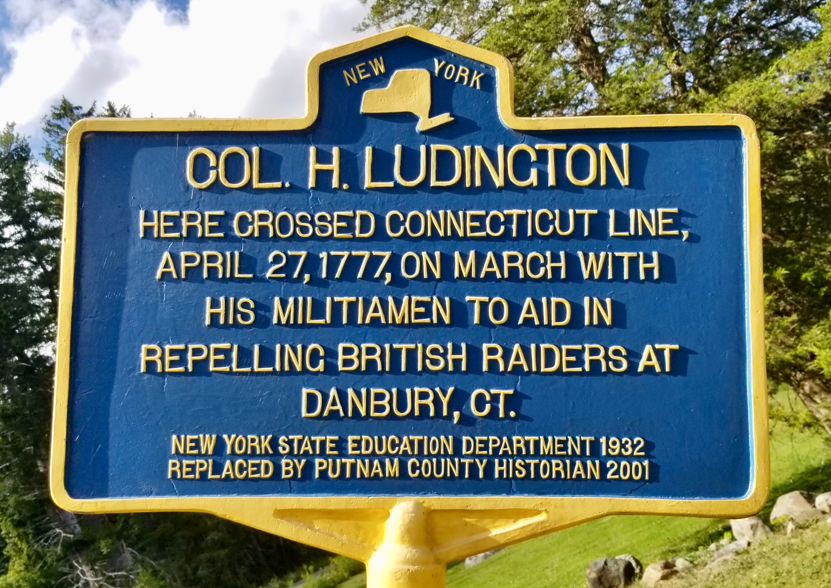 Blue and yellow New York State historic marker reading COL. H. LUDINGTON. Here crossed Connecticut line, April 27, 1777, on march with his militiamen to aid in repelling British raiders at Danbury, CT. New York State Education Department 1932. Replaced by Putnam County Historian 2001.