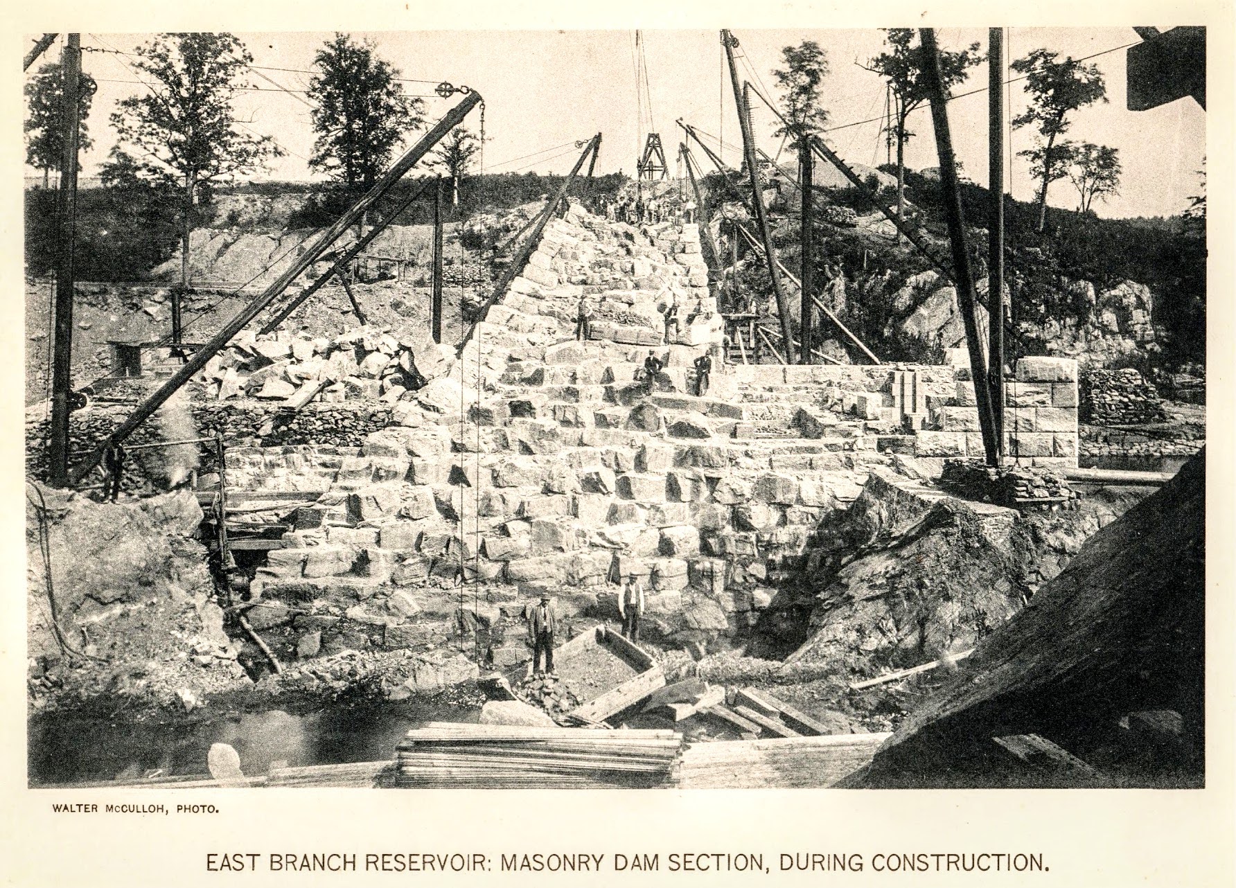 East Branch Reservoir: Masonry Dam Section — stone blocks being set, workers visible at multiple levels
